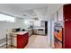 Retro kitchen featuring tile floors, white countertops, and red and white cabinetry with vintage appliances at 9010 W Lone Mountain Rd, Las Vegas, NV 89129