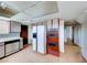 Bright kitchen with tile flooring, white refrigerator, white cabinetry, and vintage oven at 9010 W Lone Mountain Rd, Las Vegas, NV 89129