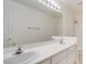 Bright bathroom featuring a double sink vanity, large mirror, and shower, offering a clean and functional space at 9776 Whitewater Canyon Ct, Las Vegas, NV 89183