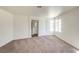 Spacious bedroom featuring neutral carpet, bright natural light, and ensuite bathroom entrance at 9776 Whitewater Canyon Ct, Las Vegas, NV 89183