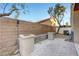 Backyard with a paved patio area and high brick wall at 7506 Village Mist Ln, Las Vegas, NV 89113