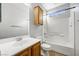 Bright bathroom featuring a shower-tub combo and wooden cabinetry at 7506 Village Mist Ln, Las Vegas, NV 89113