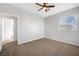 Bright bedroom with neutral walls, a ceiling fan, and a window allowing for ample natural light at 7506 Village Mist Ln, Las Vegas, NV 89113