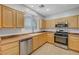 Bright kitchen featuring wooden cabinetry, stainless steel appliances, and tile flooring at 7506 Village Mist Ln, Las Vegas, NV 89113