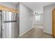 View of the bright stainless steel refrigerator in the kitchen area with tile flooring at 7506 Village Mist Ln, Las Vegas, NV 89113