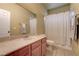 Neutral bathroom with marble countertops, light-colored tile and shower with curtain at 8307 Amtrak Express, Las Vegas, NV 89131