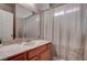 Well-lit bathroom featuring a vanity with ample counter space and a shower with a privacy curtain at 8307 Amtrak Express, Las Vegas, NV 89131