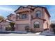Exterior elevation of home featuring balcony, two-car garage, and landscaped yard at 8307 Amtrak Express, Las Vegas, NV 89131