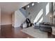 Spacious living area with high ceilings, a staircase, a comfortable sofa, and modern decor, creating a relaxing atmosphere at 8307 Amtrak Express, Las Vegas, NV 89131