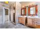 Bathroom featuring dual sinks, mosaic glass shower, and stylish light fixtures at 10024 Skipper Ct, Las Vegas, NV 89117