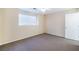Well-lit bedroom with carpeting, window, and a door leading to other areas of the house at 10024 Skipper Ct, Las Vegas, NV 89117
