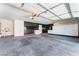 Spacious garage with ample storage cabinets and unique tile accent wall at 10024 Skipper Ct, Las Vegas, NV 89117