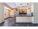 Open kitchen area featuring stainless steel appliances, island with seating, and stone flooring at 10024 Skipper Ct, Las Vegas, NV 89117