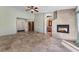 Large, open living room with tile floor, fireplace, access to the bathroom, and entryway to the walk-in closet at 10024 Skipper Ct, Las Vegas, NV 89117