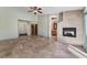 Large, open living room with tile floor, fireplace, access to the bathroom, and entryway to the walk-in closet at 10024 Skipper Ct, Las Vegas, NV 89117
