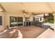 Covered outdoor kitchen featuring granite counters, stainless steel grill and a view of the sparkling pool at 10024 Skipper Ct, Las Vegas, NV 89117