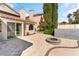 Back patio featuring a fire pit, stone pavers, and outdoor space for entertaining at 10024 Skipper Ct, Las Vegas, NV 89117