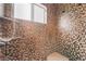 Walk-in shower showcasing elegant mosaic tile and a convenient built-in shower seat and shelving niche at 10024 Skipper Ct, Las Vegas, NV 89117