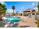 Inviting swimming pool with lush landscaping, mature palms, and backyard patio at 10024 Skipper Ct, Las Vegas, NV 89117