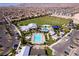 Aerial view of a community pool, splash pad, sports fields, and clubhouse amidst a well-planned neighborhood at 10196 Millholm Ave, Las Vegas, NV 89166