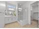Bathroom featuring a glass shower, double vanity, and ample natural light from a skylight at 10196 Millholm Ave, Las Vegas, NV 89166