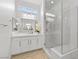 Bathroom with glass enclosed shower and double vanity with modern fixtures and neutral tones at 10196 Millholm Ave, Las Vegas, NV 89166