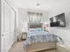 Serene bedroom with soft lighting, a plush bed, and a mounted television at 10196 Millholm Ave, Las Vegas, NV 89166