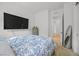 Bright bedroom features a plush bed, wall-mounted television, and plenty of closet space at 10196 Millholm Ave, Las Vegas, NV 89166