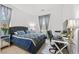 Comfortable bedroom boasts a large window and a workstation, perfect for work or study at 10196 Millholm Ave, Las Vegas, NV 89166