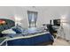 Comfortable bedroom boasts a large window and a workstation, perfect for work or study at 10196 Millholm Ave, Las Vegas, NV 89166