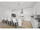 Bright kitchen featuring an island with seating, white cabinetry, and modern appliances at 10196 Millholm Ave, Las Vegas, NV 89166
