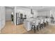 Bright kitchen features stainless appliances, white cabinets, and a large marble countertop island with seating at 10196 Millholm Ave, Las Vegas, NV 89166