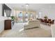 Open-concept living area with large windows, elegant furniture, and access to the outdoors at 10196 Millholm Ave, Las Vegas, NV 89166