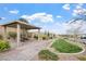 Community park pavilion with picnic seating and a paved walkway amid green space at 10196 Millholm Ave, Las Vegas, NV 89166