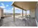 Covered patio with brick flooring, wrought iron table and chairs, and mountain views at 10196 Millholm Ave, Las Vegas, NV 89166