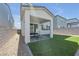 Cozy covered back patio with synthetic grass, perfect for outdoor entertaining at 10214 Natural Anchor St, Las Vegas, NV 89166