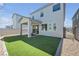 Well-maintained backyard featuring a covered patio, artificial grass, and privacy fence at 10214 Natural Anchor St, Las Vegas, NV 89166
