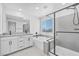 Luxurious primary bathroom with a double vanity, soaking tub, and glass-enclosed shower at 10214 Natural Anchor St, Las Vegas, NV 89166