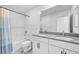 Bathroom showcasing a combined shower and tub, featuring double sinks with grey countertops at 10214 Natural Anchor St, Las Vegas, NV 89166