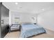 Well-lit bedroom with a queen bed, sliding barn door, and views to the outside at 10214 Natural Anchor St, Las Vegas, NV 89166