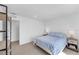 Bright bedroom with light-colored walls, carpeted floors, and a comfortable bed with side tables at 10214 Natural Anchor St, Las Vegas, NV 89166