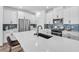Modern kitchen with white cabinetry, stainless steel appliances, and a large center island with sink at 10214 Natural Anchor St, Las Vegas, NV 89166