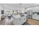 Open-concept living space with a kitchen island and a comfortable seating area at 10214 Natural Anchor St, Las Vegas, NV 89166