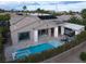 An aerial view of the backyard featuring a sparkling pool, outdoor living and beautiful landscaping at 10261 Largo Sassetta Ct, Las Vegas, NV 89135