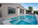 Backyard features a pool with a built-in spa and an outdoor seating area at 10261 Largo Sassetta Ct, Las Vegas, NV 89135