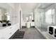 Bright bathroom featuring double vanity, ample counter space, glass shower, and soaking tub at 10261 Largo Sassetta Ct, Las Vegas, NV 89135