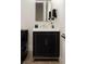 Modern bathroom with a black vanity, sleek mirror, and contemporary fixtures at 10261 Largo Sassetta Ct, Las Vegas, NV 89135