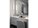 Contemporary bathroom vanity with ample storage, stylish mirror and natural light, enhancing the room's appeal at 10261 Largo Sassetta Ct, Las Vegas, NV 89135