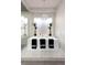 Modern soaking tub with elegant black towels and stylish lighting for a relaxing bathroom ambiance at 10261 Largo Sassetta Ct, Las Vegas, NV 89135