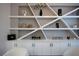 Elegant built-in shelving with wine storage and decorative items enhance the room's aesthetic at 10261 Largo Sassetta Ct, Las Vegas, NV 89135